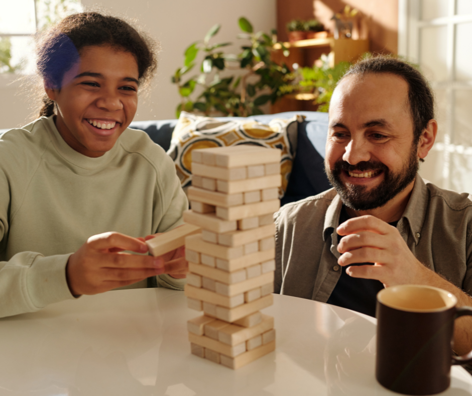 Two teenagers; one looking delighted holding a budgie